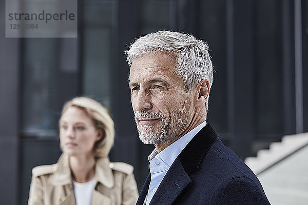Portrait of mature businessman with grey hair and beard outdoors