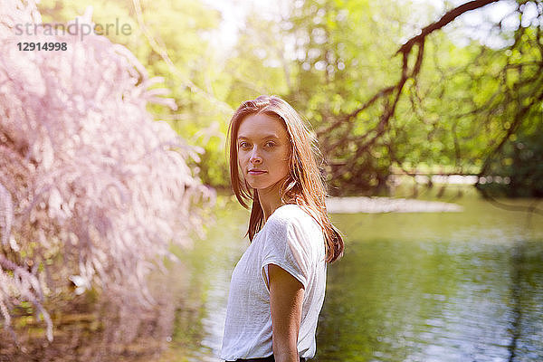 Portrait of attractive young woman at a pond