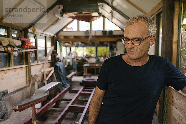 Portrait of a mature man in his workshop