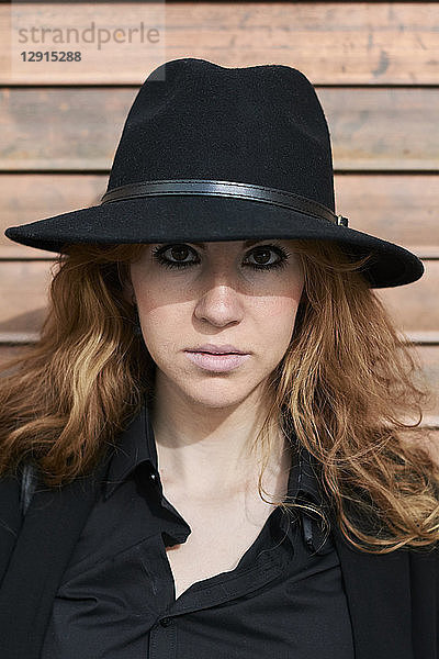 Mid adult woman wearing black hat