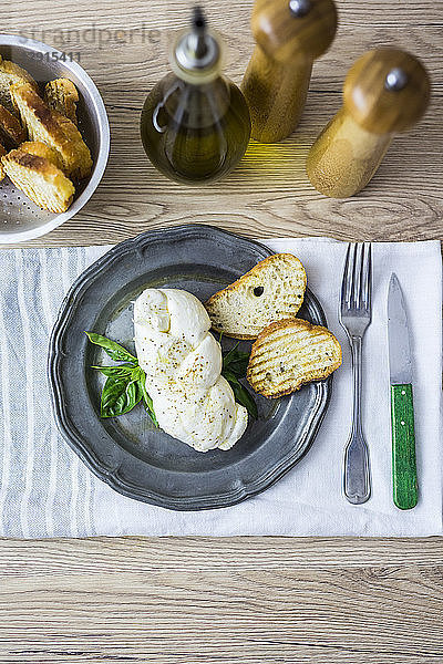 Mozzarella braid  basil and bread on plate