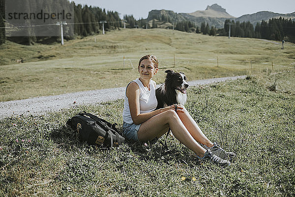 Austria  Vorarlberg  Mellau  woman with dog on a trip in the mountains