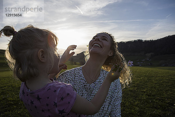 Austria  Tyrol  Walchsee  happy mother with daughter on an alpine meadow
