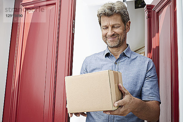 Mature man receiving a package at his door