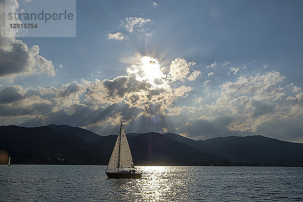 Germany  Bavaria  Upper Bavaria  Tegernsee valley  lake Tegernsee  Bad Wiessee  Sailing boat at sunset  seen from peninsula Point