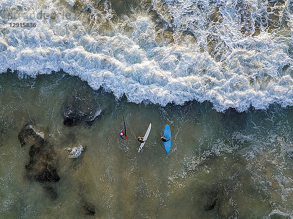 Indonesia  Bali  Aerial view of Dreamland beach  three surfers from above