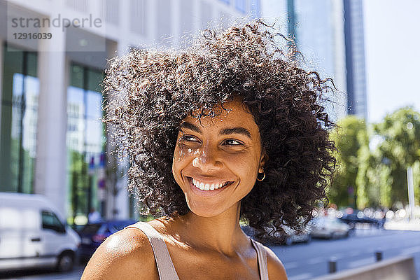 Germany  Frankfurt  portrait of laughing young woman with curly hair