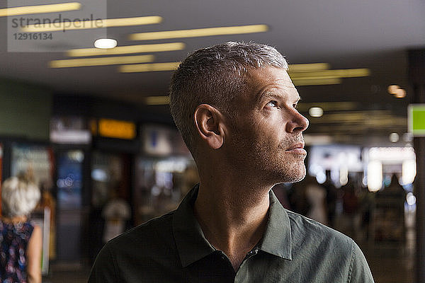 Portrait of a mature man in the city looking sideways