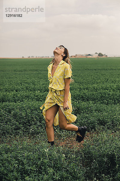 Young woman walking in a green field