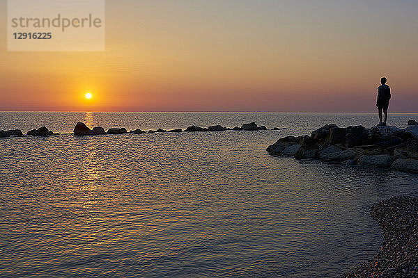 Italy  Abruzzo  San Vito Chietino  Trabocchi coast  man looking at distance during sunrise