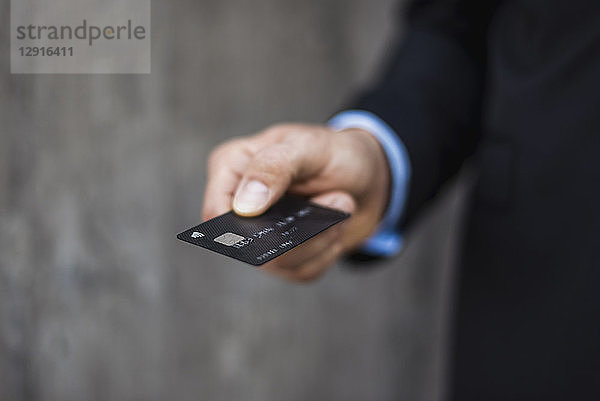 Close-up of businessman holding credit card
