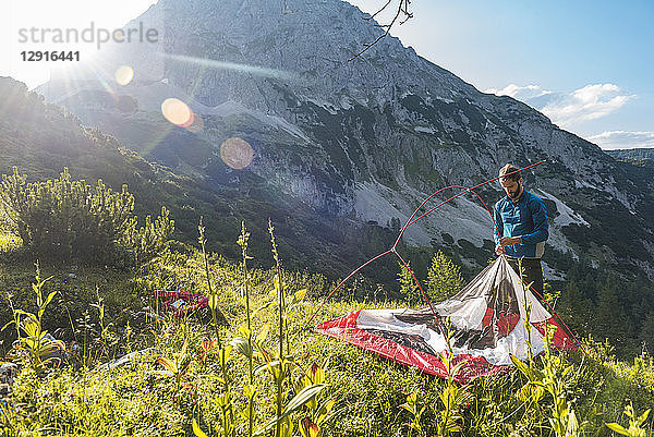 Austria  Tyrol  Hiker setting up his tent in the mountains