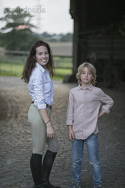 Portrait of young woman and boy on a farm