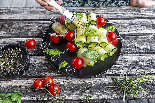Vegetarian grill skewers  tomato and zucchini slices  brush with rosemary garlic oil