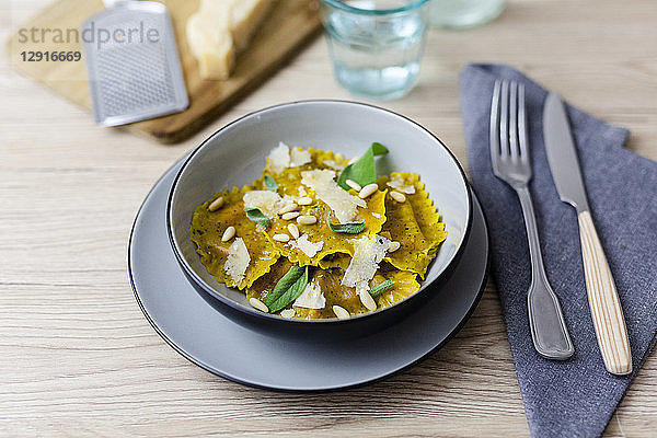 Ravioli vegan with sage leaves  pine nuts and grana cheese