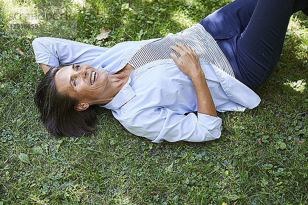 Portrait of mature woman relaxing on a meadow