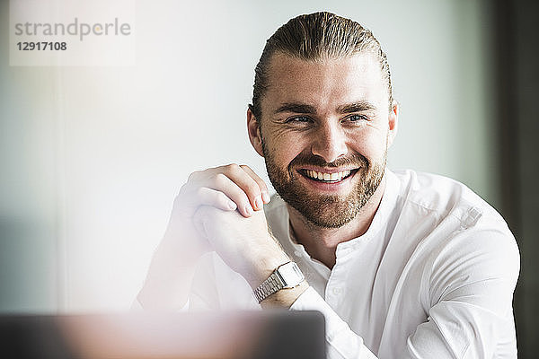 Portrait of smiling young businessman in office