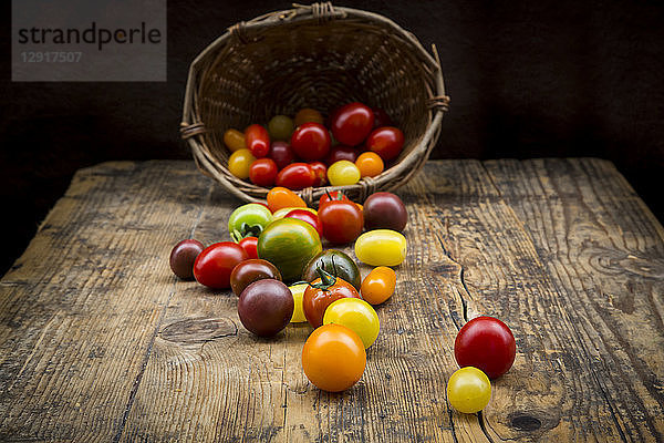 Basket of Heirloom tomatoes on wood