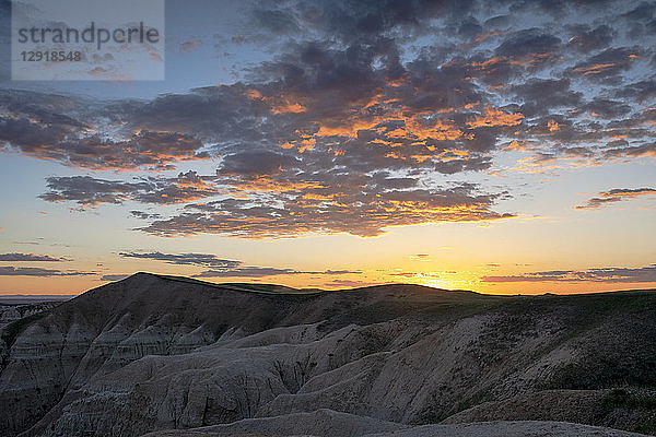 Felsformationen im Badlands National Park bei bewölktem Sonnenuntergang  South Dakota  USA