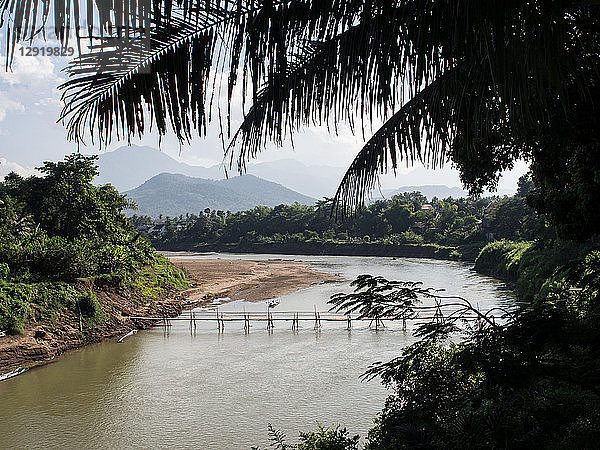 Nam Kang Fluss mit Bergen  Bambusbrücke und Palmen  Luang Prabang  Laos  Indochina  Südostasien  Asien