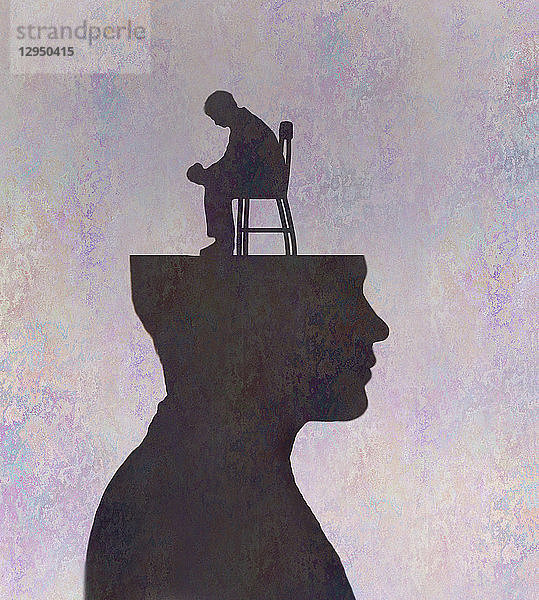 Depressiver Mann sitzt im Kopf eines Mannes