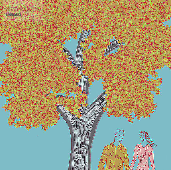 Junges Paar hält sich an den Händen unter einem Baum