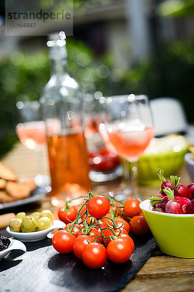 Urlaub Sommer Brunch Party Tisch im Freien im Haus Hinterhof mit Vorspeise  Glas Rosewein  frisches Getränk und Bio-Gemüse.