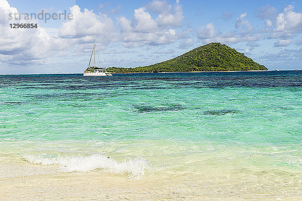 Blick auf die Insel Petit-St-Vincent und ein Segelboot  St. Vincent und die Grenadinen  Kleine Antillen  Westindische Inseln  Inseln über dem Winde  Karibik  Mittelamerika