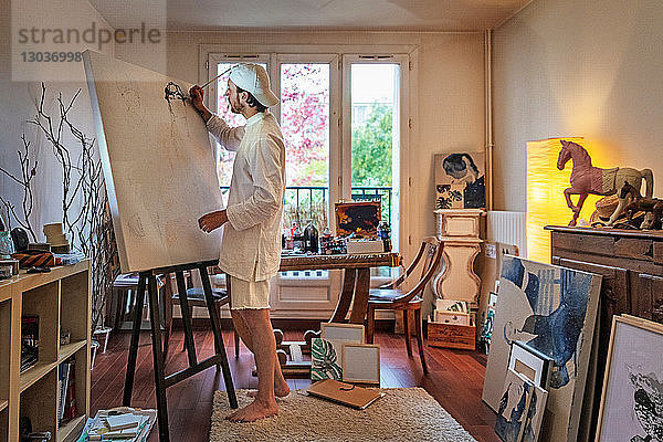 Künstlerin  die im Atelier auf Leinwand arbeitet