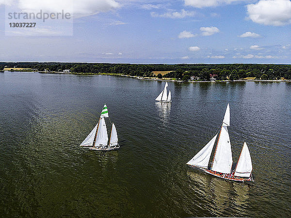 An einem warmen Sommertag nehmen Segelboote an einer Segelregatta an der Ostküste von Maryland teil. Die mehrere Stunden von Washington  DC  entfernte Region ist neben ihren Meeresfrüchten auch für das Segeln in der Chesapeake Bay bekannt.