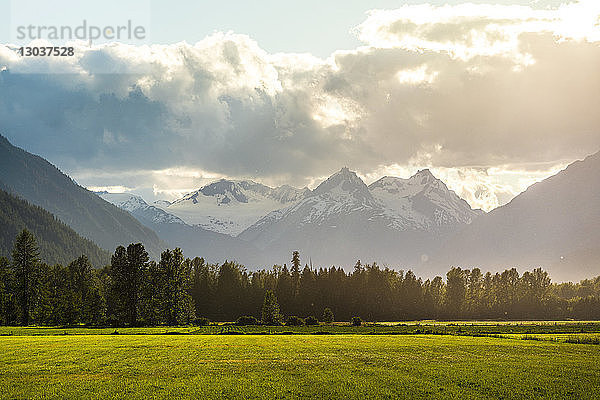 Ein Feld im Pemberton Valley liegt unterhalb des Plinth Peak im Spätsommerlicht  das durch die Wolken scheint. Pemberton Valley  auch Spud Valley genannt  ist eine bedeutende landwirtschaftliche Gemeinde  die für die Erzeugung von Saatkartoffeln bekannt ist  Pemberton  British Columbia  Kanada