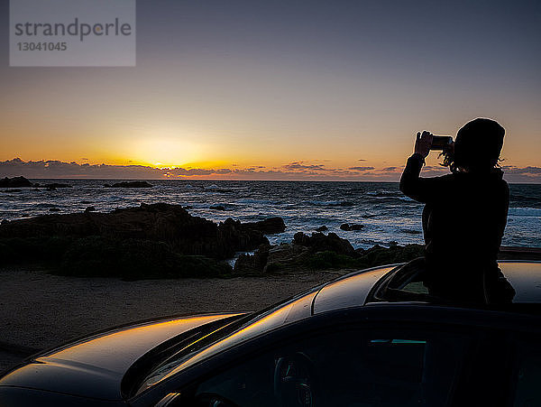 Silhouette eines Teenagers fotografiert  während er im Sonnendach steht