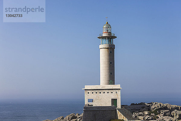 Leuchtturm Punta Nariga auf dem Meer bei klarem Himmel