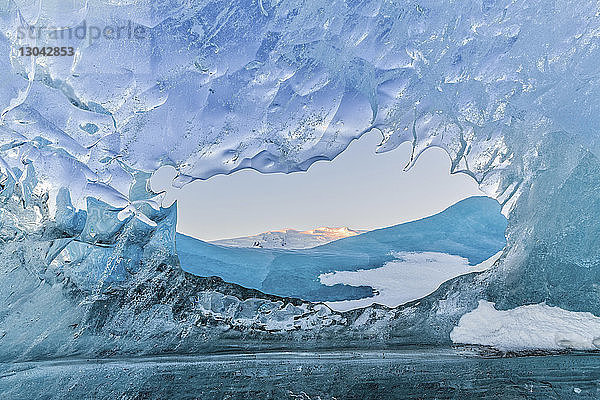 Landschaftliche Ansicht der schneebedeckten Berge durch den Gletscher gesehen