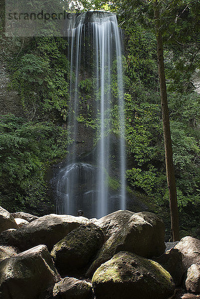 Idyllische Tiefwinkelansicht eines Wasserfalls im Wald