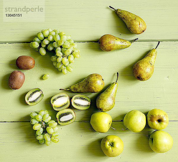 Draufsicht auf verschiedene Früchte auf Holztisch