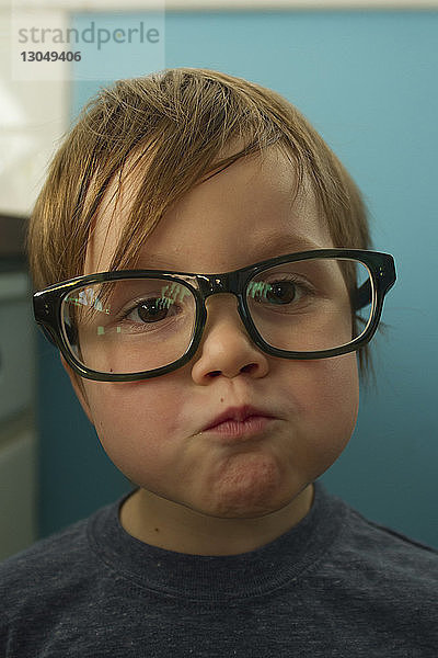 Nahaufnahme-Porträt eines süßen Jungen mit Brille  der zu Hause eine Brille trägt