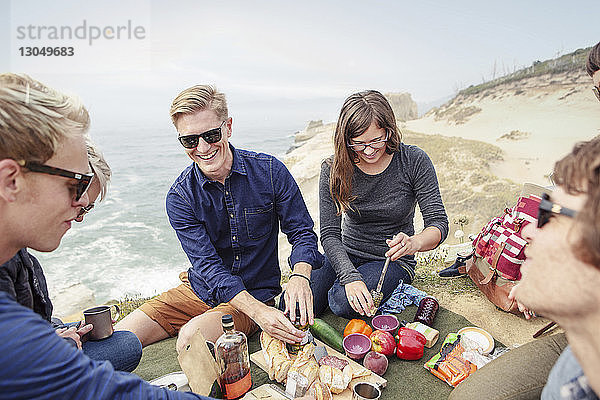 Freunde essen im Urlaub am Strand