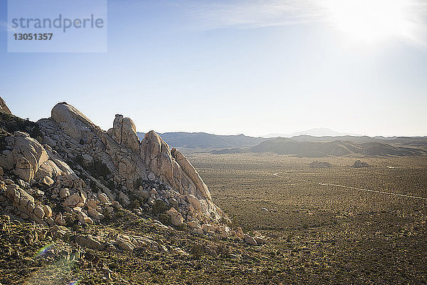 Landschaftliche Gegenüberstellung von Landschaft und Himmel im Joshua-Tree-Nationalpark an einem sonnigen Tag