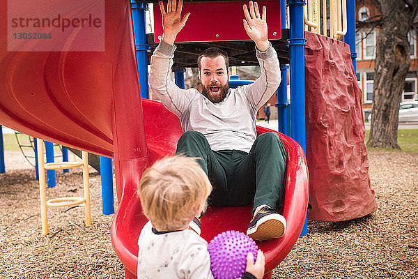 Junge sieht Vater beim Dia-Spiel an