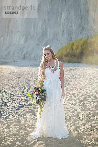 Braut mit Brautstrauss am Strand