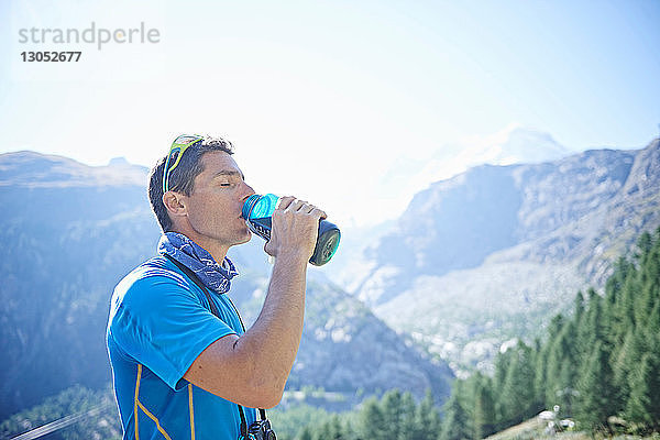 Wanderer  der aus der Wasserflasche trinkt  Mont Cervin  Matterhorn  Wallis  Schweiz
