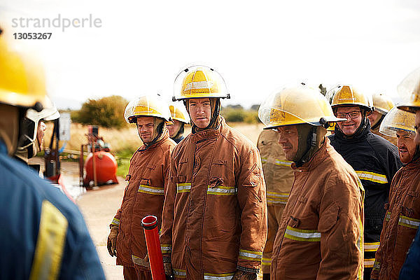 Ausbildung von Feuerwehrleuten  Team von Feuerwehrleuten  die bei einem Treffen in der Ausbildungseinrichtung zuhören