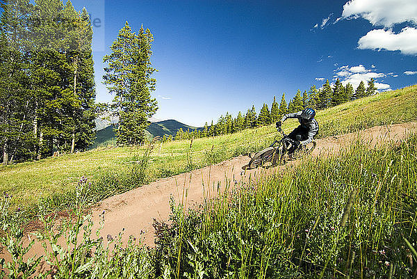 Mountainbiker fahren Fahrrad auf Wanderweg gegen den Himmel