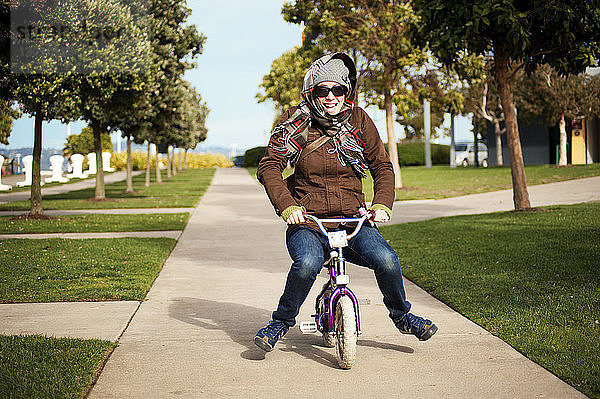 Porträt einer Fahrrad fahrenden Frau im Park