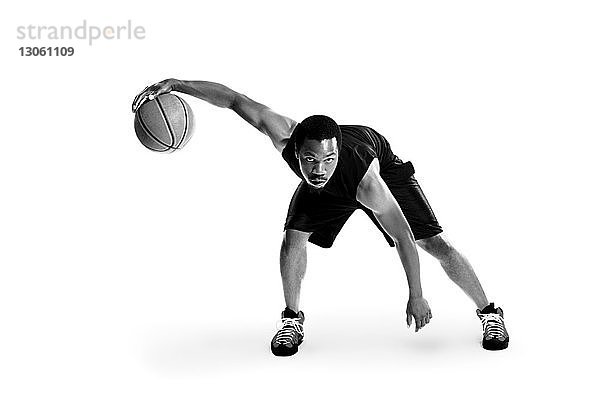 Porträt eines selbstbewussten Basketballspielers vor weissem Hintergrund