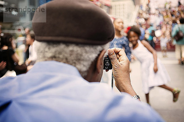 Rückansicht eines Großvaters  der Enkelkinder in der Stadt fotografiert