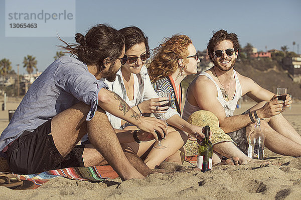 Freunde genießen Getränke am Strand