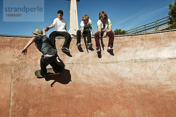 Mann gibt einem Freund beim Skateboarden ein High-Five