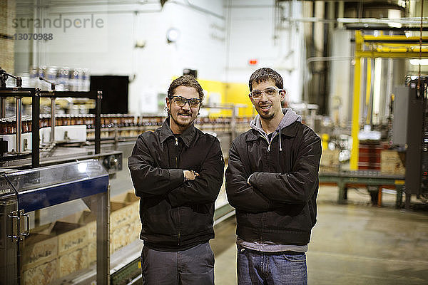 Porträt von Männern mit verschränkten Armen in der Brauerei